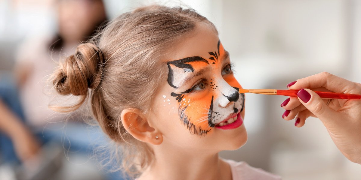 Child with facepaint as a tiger