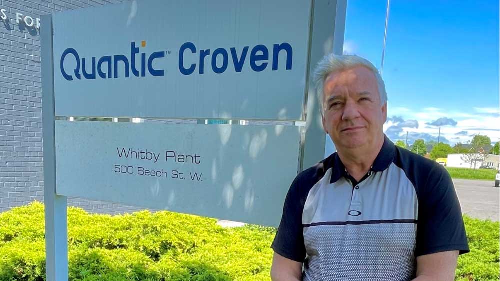 Quantic Croven Managing Director, Luke Mueller standing in front of business sign
