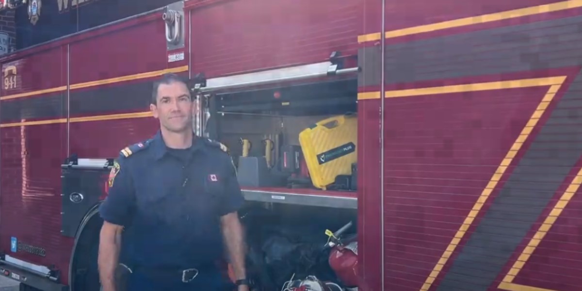 Fire Captain Josh Roy standing with a Whitby fire truck