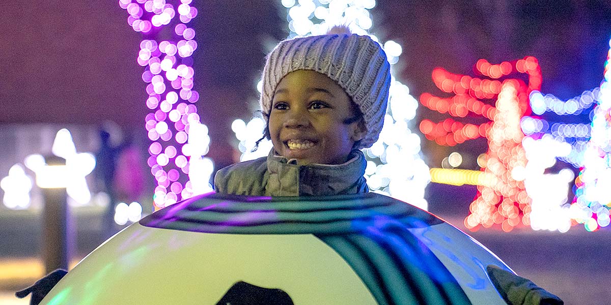 A little girl smiling at Whitby Lights the Night