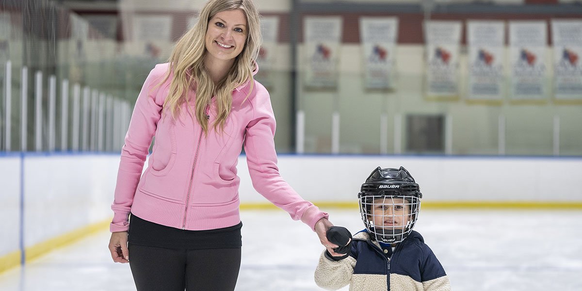 Mom skating with her child hand in hand.